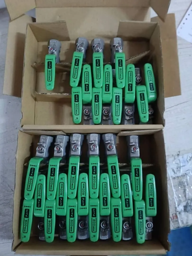 Open cartons of small-bore lever ball valves, each handle sleeved and marked with size and rating